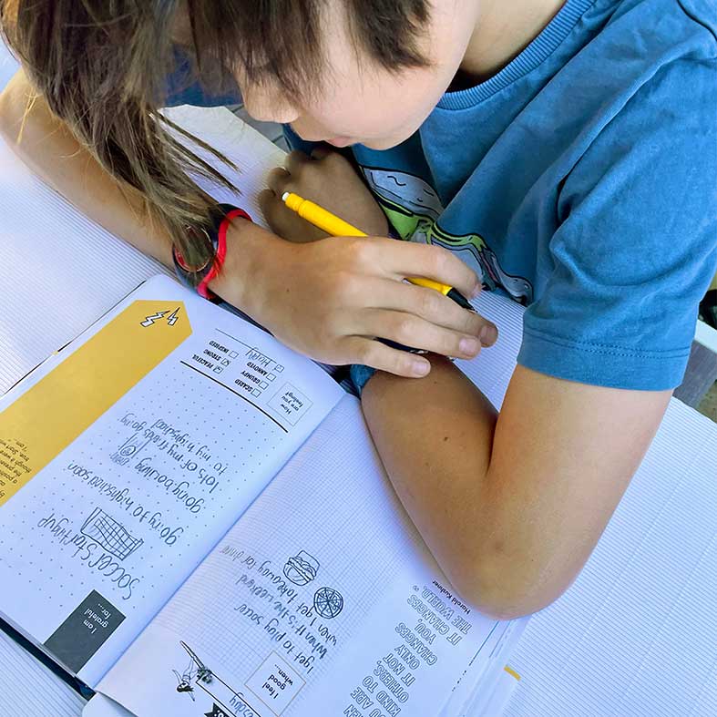 Teen using their Teen Edition Gratitude Grow Journal